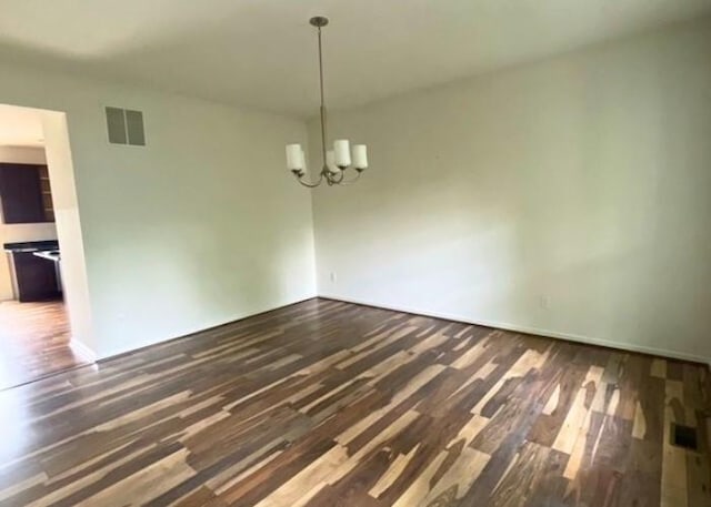 116 Sweet Cherry Way, Grover, MO 63040 - unfurnished dining area with dark wood finished floors, a chandelier, and baseboards