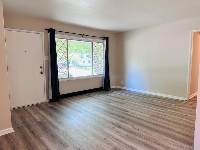 9715 Millburn Dr, Saint Louis, MO 63136 - empty room with baseboards and wood finished floors