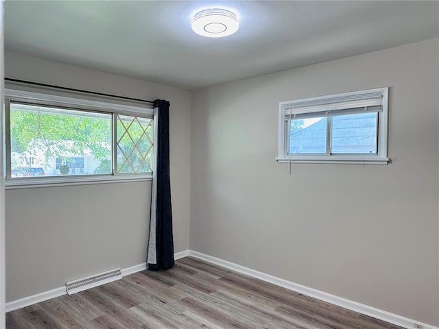 9715 Millburn Dr, Saint Louis, MO 63136 - spare room with wood finished floors and baseboards