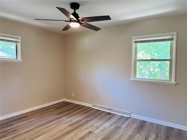 9715 Millburn Dr, Saint Louis, MO 63136 - spare room with wood finished floors, a baseboard heating unit, baseboards, and a ceiling fan