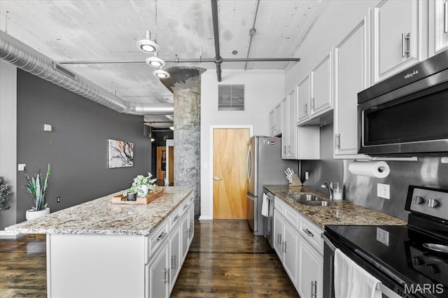 2020 Washington Ave Unit 210, Saint Louis, MO 63103 - kitchen featuring appliances with stainless steel finishes, dark wood-style floors, and white cabinets