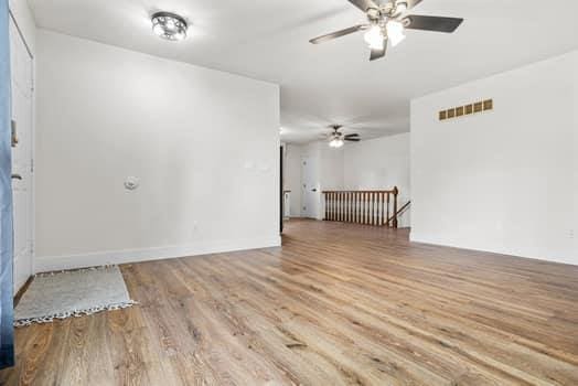 352 Della Dr, Saint Peters, MO 63376 - unfurnished room featuring wood finished floors, a ceiling fan, and baseboards