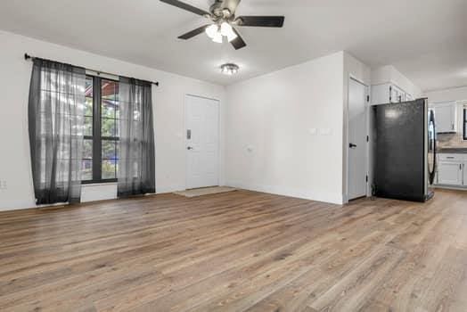 352 Della Dr, Saint Peters, MO 63376 - unfurnished living room with light wood finished floors and a ceiling fan
