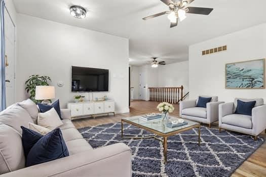 352 Della Dr, Saint Peters, MO 63376 - living room featuring a ceiling fan and wood finished floors