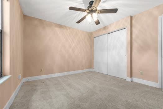 352 Della Dr, Saint Peters, MO 63376 - unfurnished bedroom featuring carpet floors, baseboards, a closet, and ceiling fan