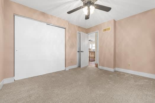 352 Della Dr, Saint Peters, MO 63376 - unfurnished bedroom with carpet, baseboards, and a ceiling fan