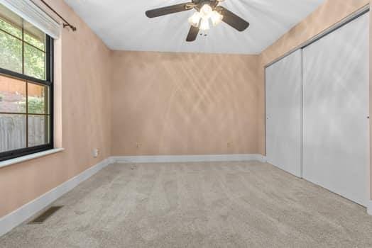 352 Della Dr, Saint Peters, MO 63376 - unfurnished bedroom featuring carpet flooring, a closet, baseboards, and a ceiling fan