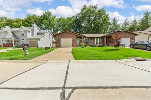 352 Della Dr, Saint Peters, MO 63376 - view of front of home with concrete driveway, a front yard, and an attached garage