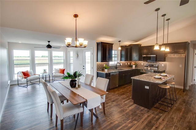 176 Bay Meadow Cir, Moro, IL 62067 - dining area with a ceiling fan, dark wood-style floors, vaulted ceiling, and a chandelier