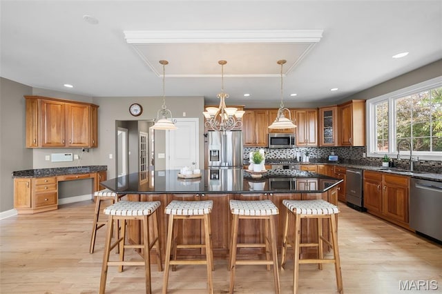 4516 Austin Point Ct, Saint Charles, MO 63304 - kitchen featuring appliances with stainless steel finishes, brown cabinets, light wood-style flooring, and recessed lighting