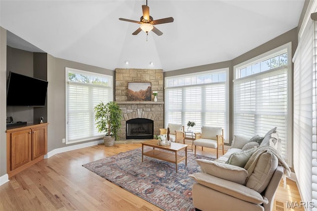4516 Austin Point Ct, Saint Charles, MO 63304 - living area with lofted ceiling, ceiling fan, a stone fireplace, and light wood-type flooring