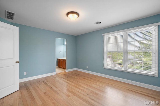 4516 Austin Point Ct, Saint Charles, MO 63304 - unfurnished bedroom featuring light wood-type flooring and connected bathroom