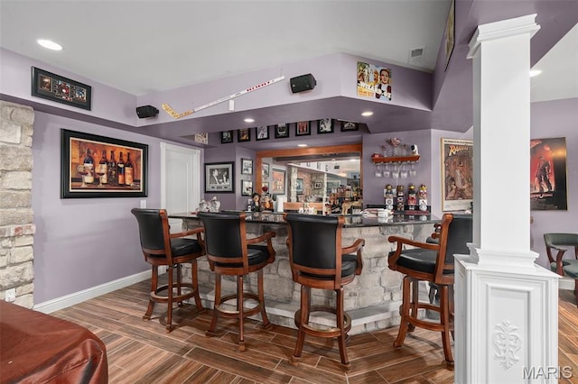 4516 Austin Point Ct, Saint Charles, MO 63304 - indoor bar featuring decorative columns, wood finished floors, and recessed lighting
