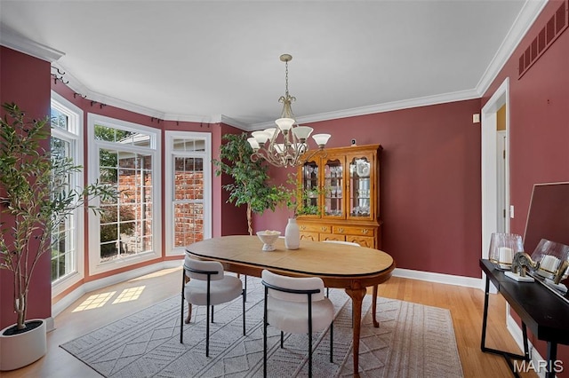 4516 Austin Point Ct, Saint Charles, MO 63304 - dining area featuring a chandelier, light wood-style floors, and crown molding