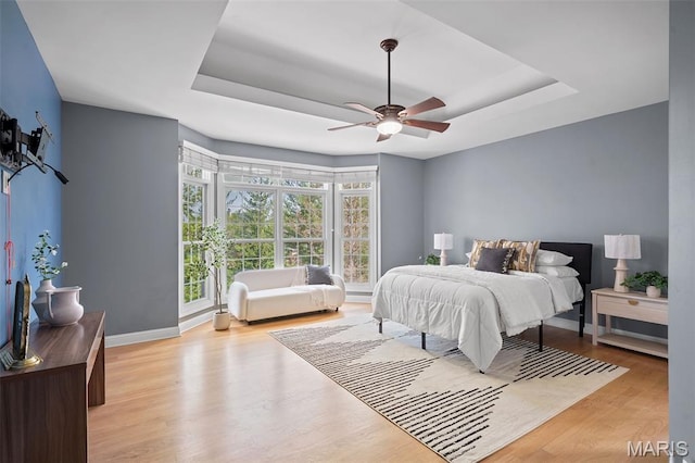 4516 Austin Point Ct, Saint Charles, MO 63304 - bedroom featuring a tray ceiling, wood finished floors, and ceiling fan