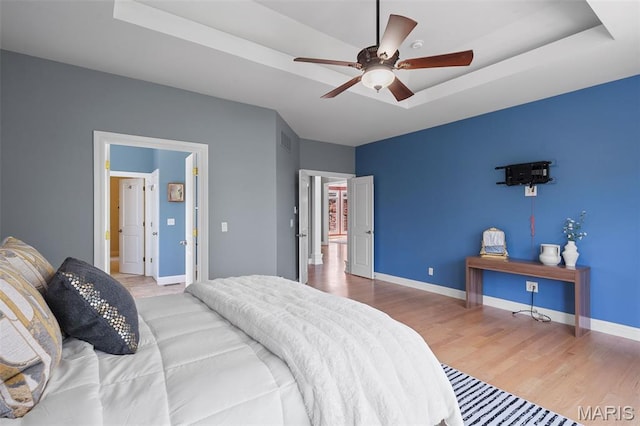 4516 Austin Point Ct, Saint Charles, MO 63304 - bedroom featuring a tray ceiling, wood finished floors, and ceiling fan