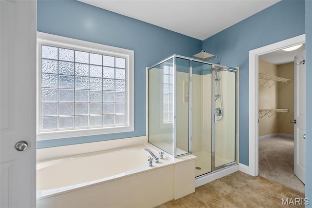 4516 Austin Point Ct, Saint Charles, MO 63304 - bathroom featuring a shower stall, a garden tub, a spacious closet, and tile patterned flooring