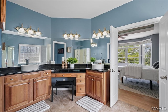 4516 Austin Point Ct, Saint Charles, MO 63304 - ensuite bathroom featuring double vanity, a shower stall, ceiling fan, and tile patterned floors