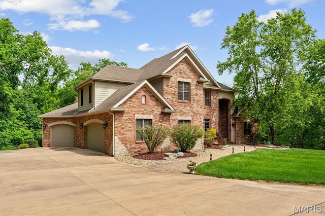 4516 Levis Ln, Godfrey, IL 62035 - traditional home featuring driveway, a garage, brick siding, a front yard, and a shingled roof