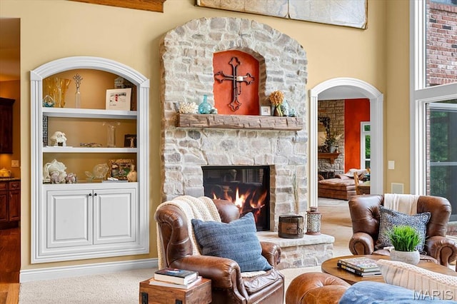 4516 Levis Ln, Godfrey, IL 62035 - living room featuring a stone fireplace and arched walkways
