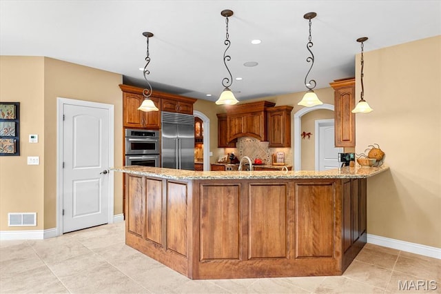 4516 Levis Ln, Godfrey, IL 62035 - kitchen featuring stainless steel appliances, light stone counters, a peninsula, baseboards, and recessed lighting