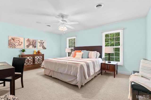 4516 Levis Ln, Godfrey, IL 62035 - bedroom featuring light carpet, multiple windows, a ceiling fan, and baseboards