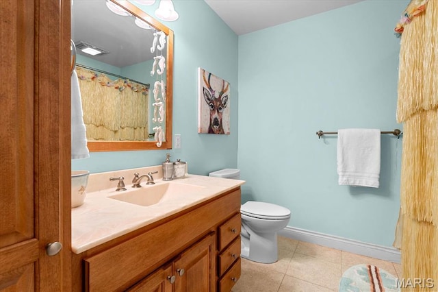 4516 Levis Ln, Godfrey, IL 62035 - full bath featuring vanity, toilet, tile patterned floors, and baseboards