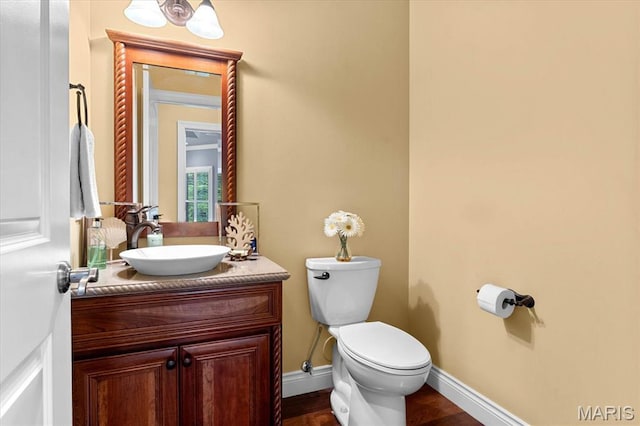 4516 Levis Ln, Godfrey, IL 62035 - bathroom with vanity, toilet, baseboards, and wood finished floors
