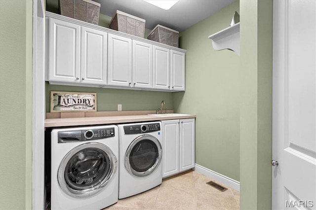 4516 Levis Ln, Godfrey, IL 62035 - laundry area featuring washer and clothes dryer, cabinet space, light tile patterned floors, and baseboards