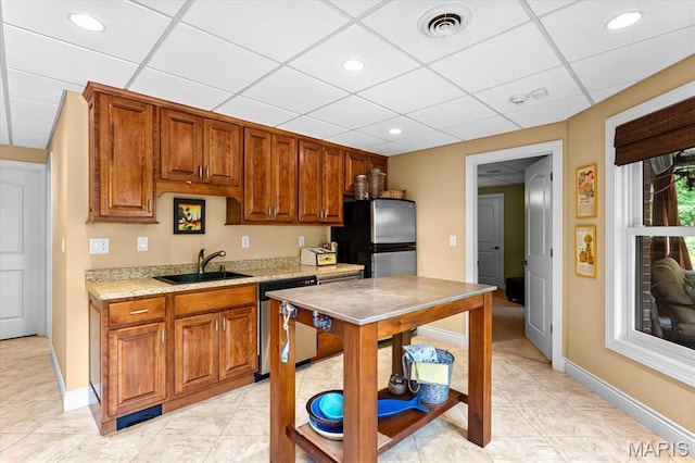 4516 Levis Ln, Godfrey, IL 62035 - kitchen with appliances with stainless steel finishes, a sink, brown cabinets, baseboards, and recessed lighting