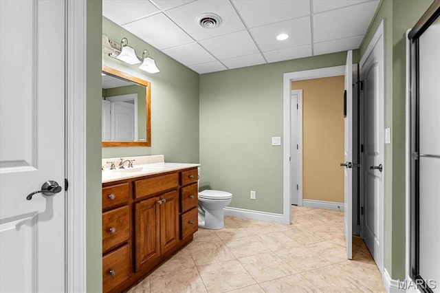 4516 Levis Ln, Godfrey, IL 62035 - bathroom featuring a drop ceiling, vanity, toilet, recessed lighting, and baseboards