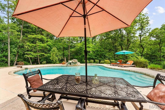 4516 Levis Ln, Godfrey, IL 62035 - outdoor pool with a patio area and view of wooded area