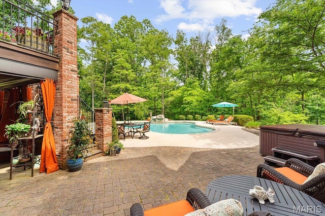 4516 Levis Ln, Godfrey, IL 62035 - swimming pool featuring a hot tub, a patio area, and view of scattered trees