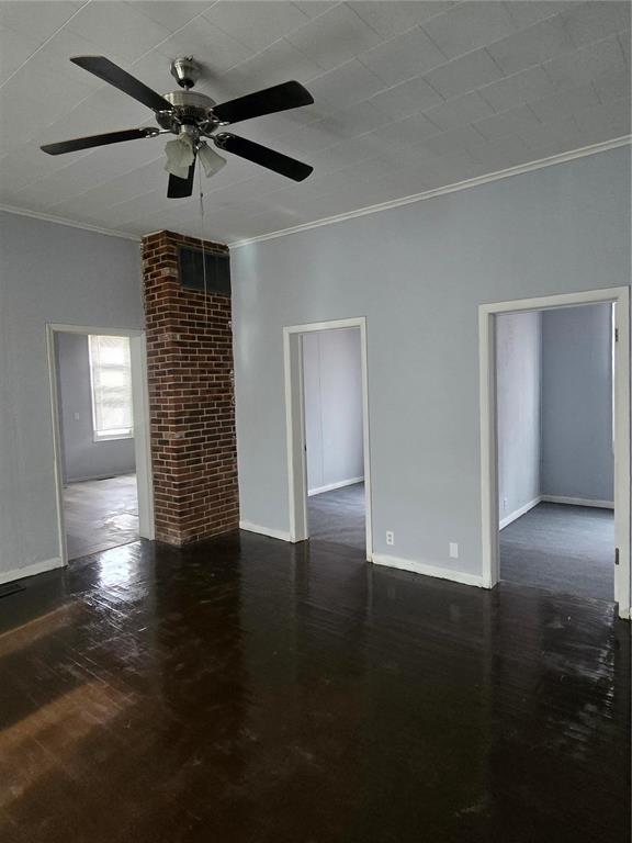 633 4th St, Carrollton, IL 62016 - unfurnished room featuring crown molding, a ceiling fan, baseboards, and wood finished floors