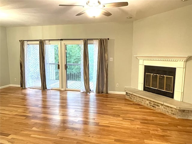 13613 Mason Oaks Ln Unit 3, Saint Louis, MO 63131 - unfurnished living room with ceiling fan, wood finished floors, baseboards, and a fireplace