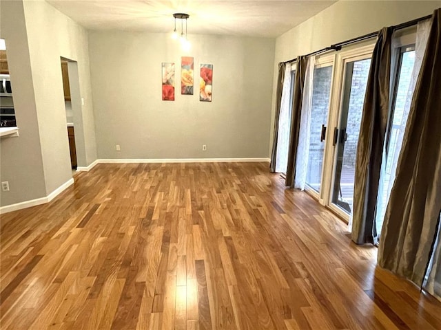 13613 Mason Oaks Ln Unit 3, Saint Louis, MO 63131 - unfurnished dining area featuring plenty of natural light, wood finished floors, and baseboards