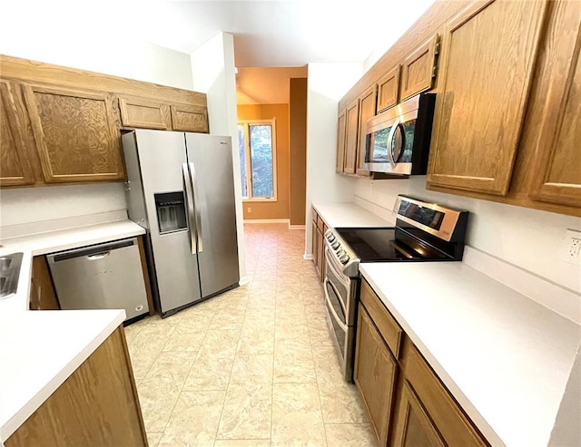 13613 Mason Oaks Ln Unit 3, Saint Louis, MO 63131 - kitchen with stainless steel appliances, light countertops, and brown cabinets