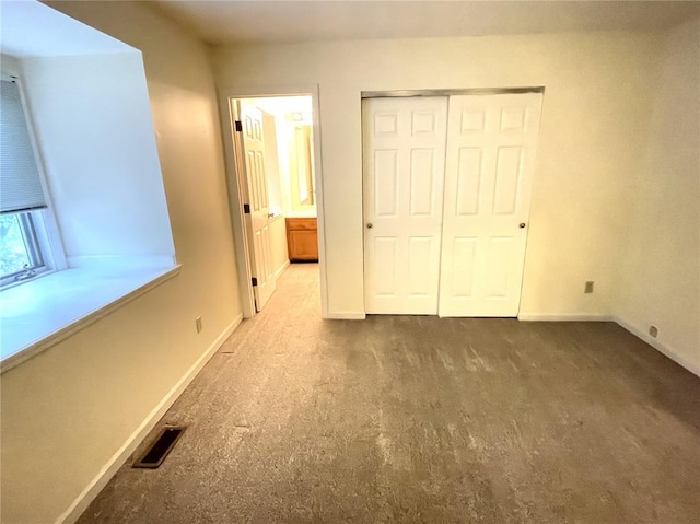 13613 Mason Oaks Ln Unit 3, Saint Louis, MO 63131 - unfurnished bedroom featuring baseboards, carpet flooring, and a closet
