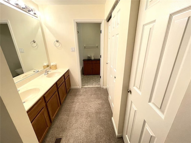 13613 Mason Oaks Ln Unit 3, Saint Louis, MO 63131 - bathroom with double vanity, baseboards, carpet flooring, and toilet