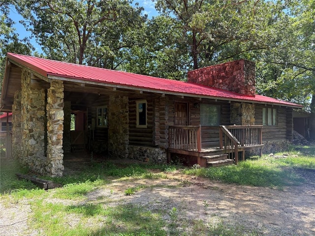 232 Ripley Unit A-1, Doniphan, MO 63935 - view of front of property featuring metal roof, log exterior, covered porch, and a chimney