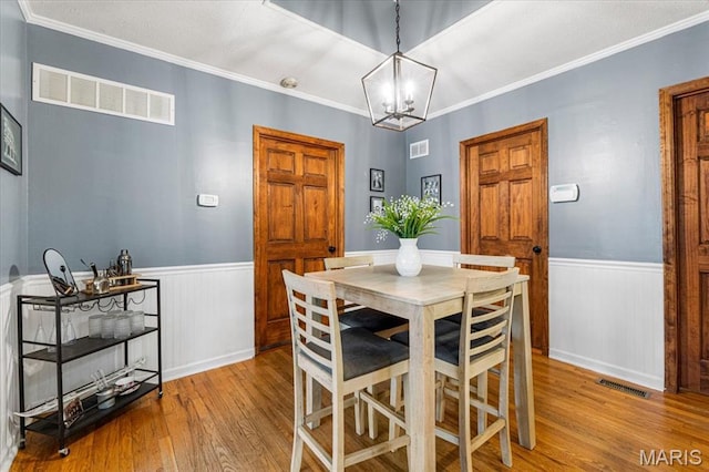 507 Alphonse Dr, Kirkwood, MO 63122 - dining space with a wainscoted wall, wood finished floors, a chandelier, and ornamental molding