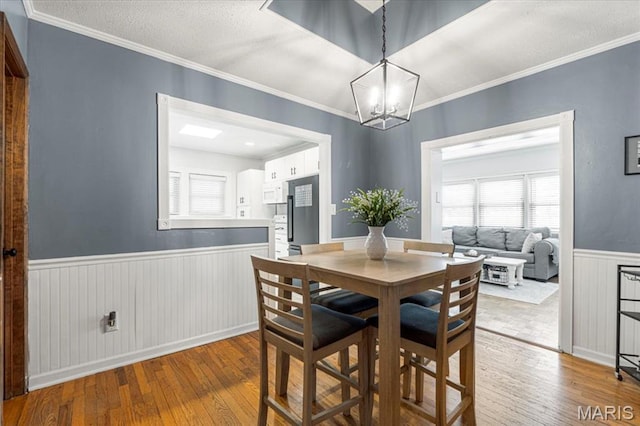 507 Alphonse Dr, Kirkwood, MO 63122 - dining area featuring wainscoting, wood-type flooring, a chandelier, and ornamental molding