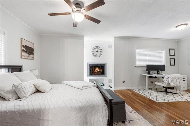 507 Alphonse Dr, Kirkwood, MO 63122 - bedroom featuring light wood finished floors, crown molding, baseboards, a fireplace, and a ceiling fan