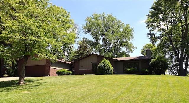 11 Glen Hollow Rd, Glen Carbon, IL 62034 - view of front of home featuring a chimney, a front lawn, and an attached garage
