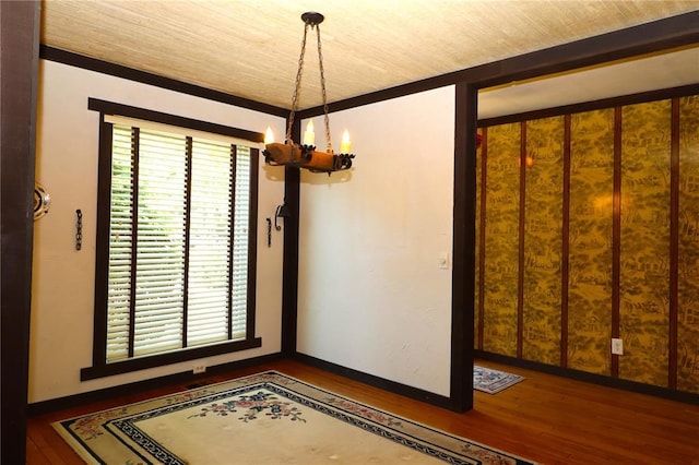 11 Glen Hollow Rd, Glen Carbon, IL 62034 - spare room with a chandelier, wood finished floors, and baseboards