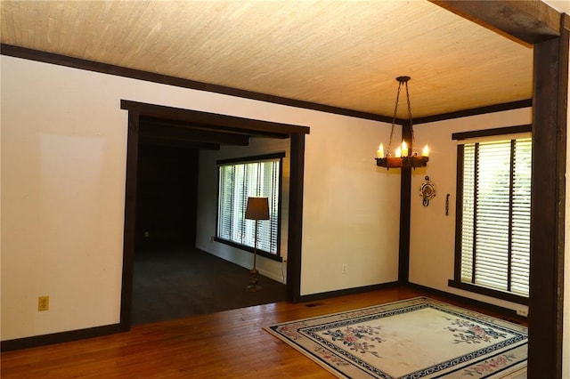 11 Glen Hollow Rd, Glen Carbon, IL 62034 - unfurnished room with wood finished floors, a chandelier, wood ceiling, baseboards, and ornamental molding