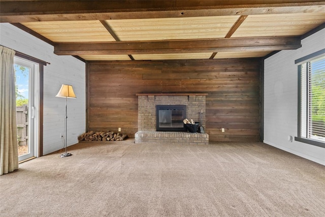 11 Glen Hollow Rd, Glen Carbon, IL 62034 - unfurnished living room featuring plenty of natural light, wooden walls, wooden ceiling with exposed beams, carpet, and a fireplace