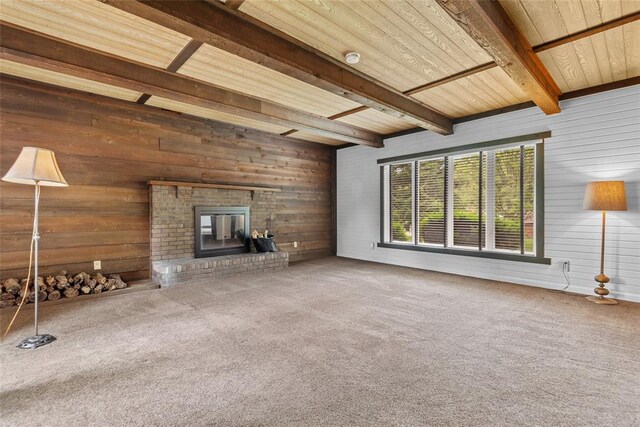 11 Glen Hollow Rd, Glen Carbon, IL 62034 - unfurnished living room featuring wooden walls, carpet floors, beam ceiling, and a fireplace