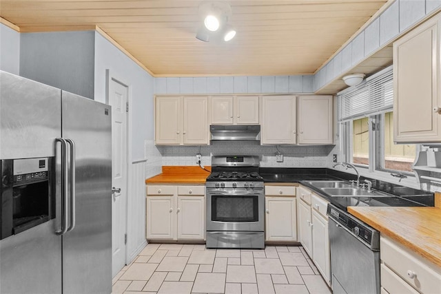 11 Glen Hollow Rd, Glen Carbon, IL 62034 - kitchen with stainless steel appliances, under cabinet range hood, a sink, butcher block counters, and wood ceiling