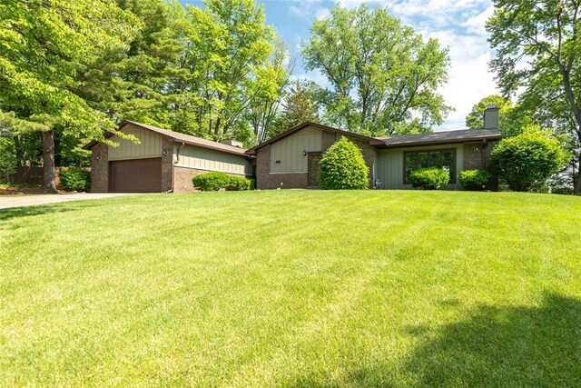 11 Glen Hollow Rd, Glen Carbon, IL 62034 - view of front facade featuring a chimney, a front lawn, and brick siding